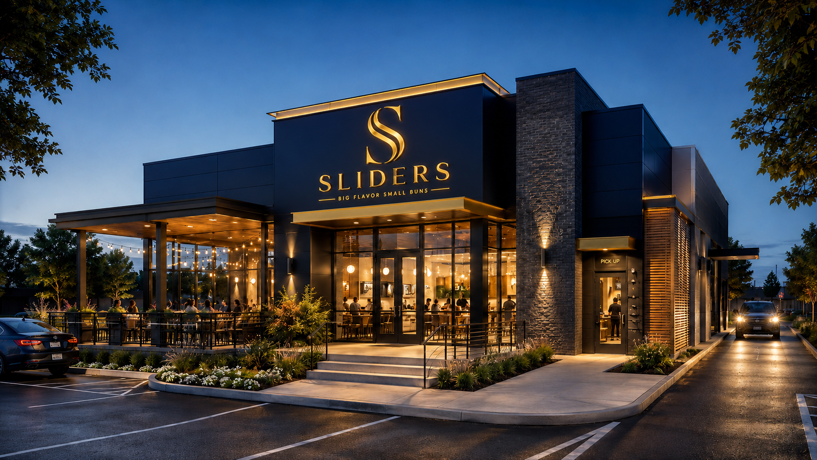 Sliders restaurant exterior at dusk — navy and gold facade with outdoor patio and warm interior lighting